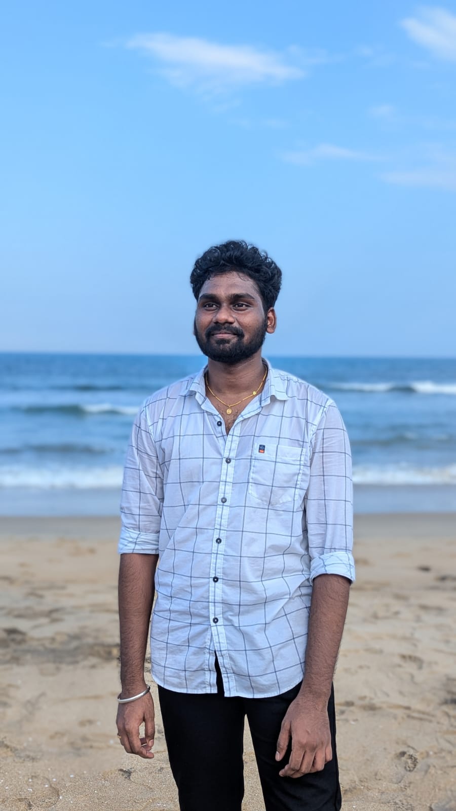 Rakesh standing alone on the beach