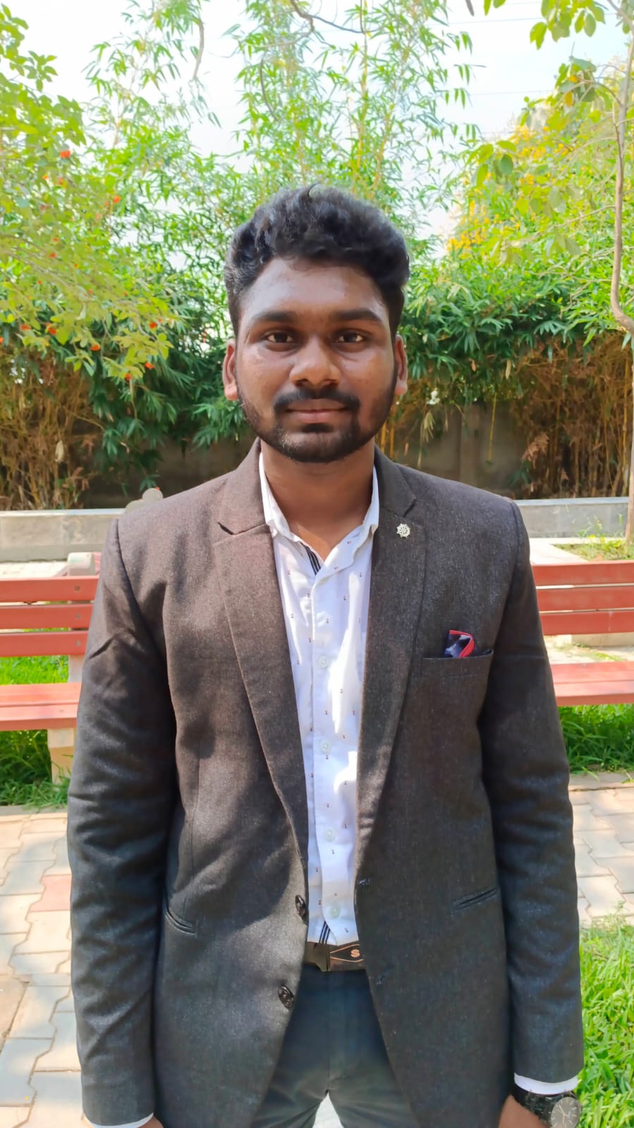 Rakesh standing alone in a suit
