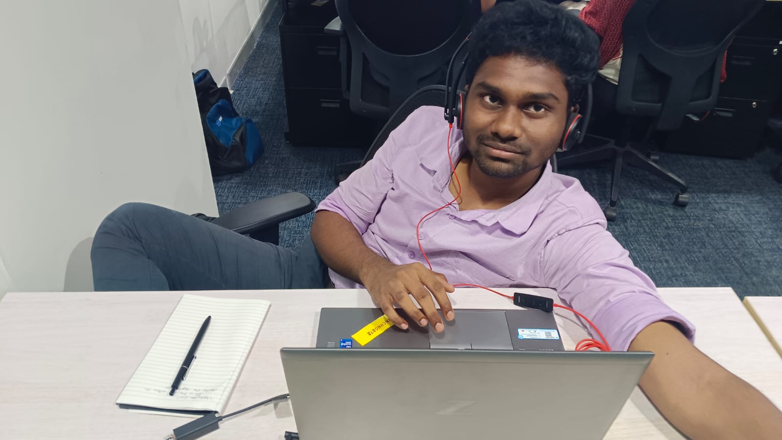 Rakesh seated alone at his desk in the office