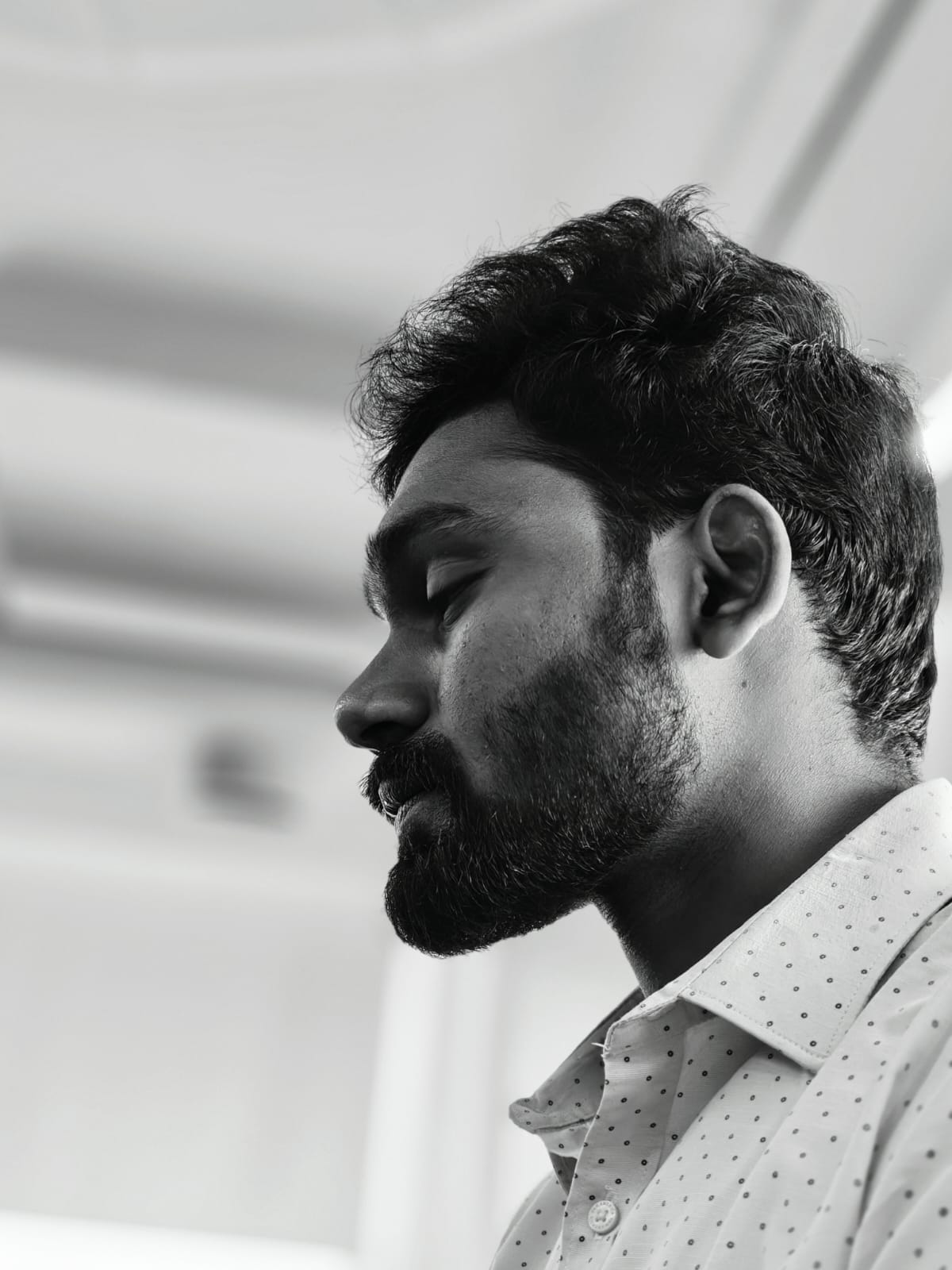 Rakesh in a solo black-and-white profile portrait